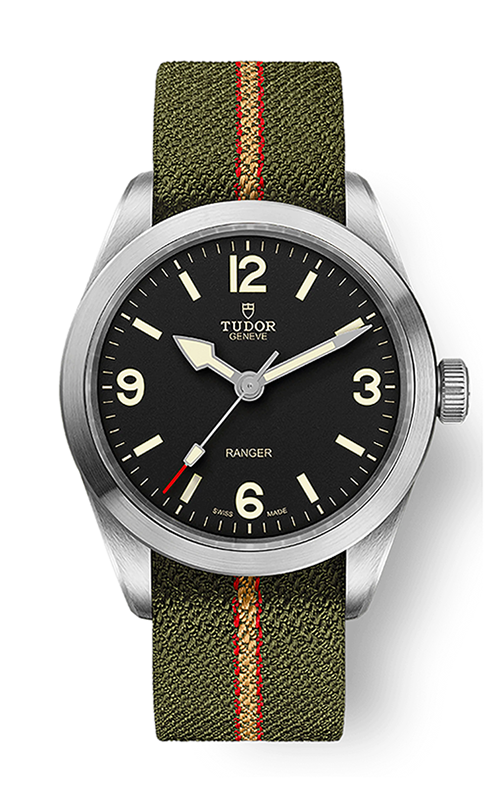 A TUDOR Ranger watch with black dial, arabic numerals at 3,6,9,12, and olive green rubber band with red stripes.