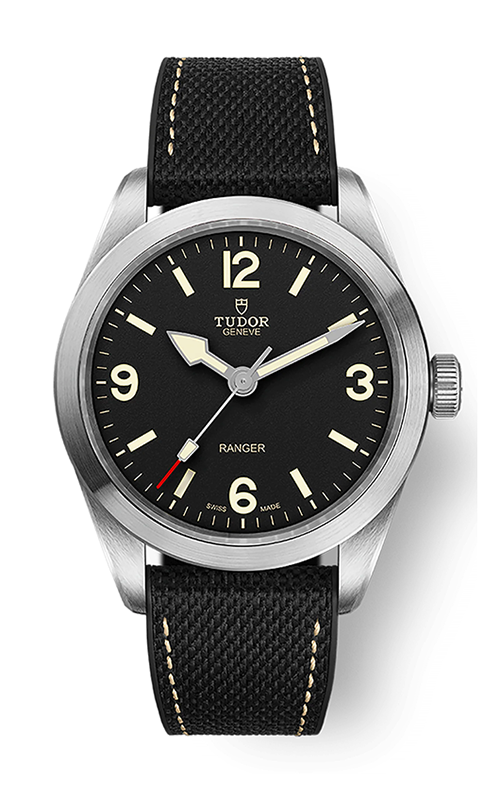 A TUDOR Ranger watch with black dial, arabic numerals at 3,6,9,12, and black rubber band.
