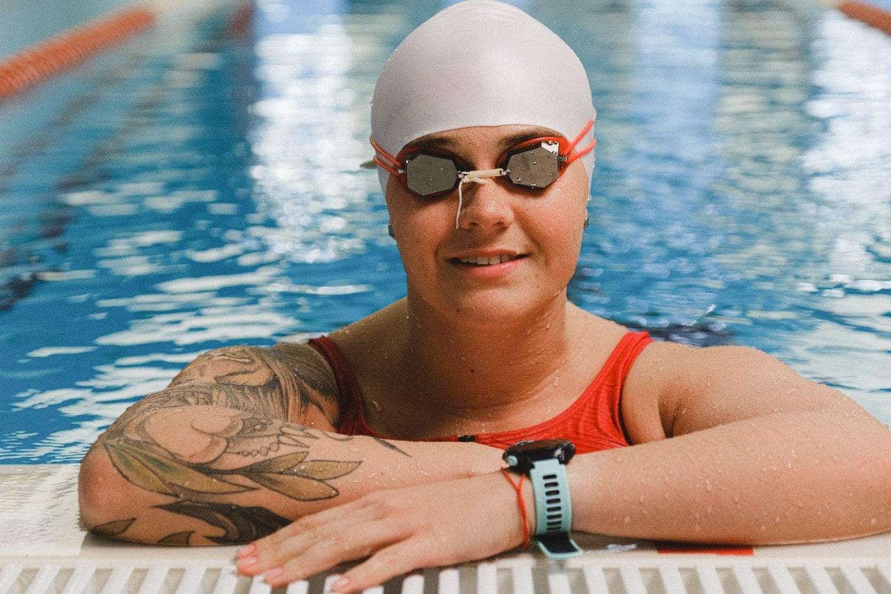 A close-up of a swimmer wearing a sports watch after swimming laps.