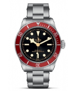 A TUDOR Black Bay 41 watch with a stainless steel strap and black dial with a red bezel, available at La Différence Time Centre.
