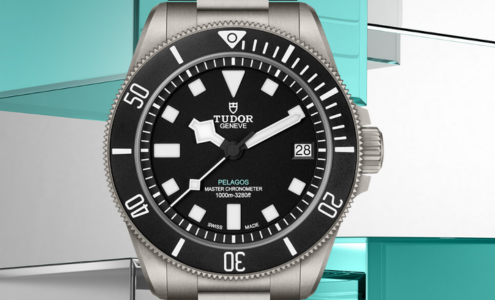 A close-up of a TUDOR Pelagos watch on a colourful geometric backdrop.